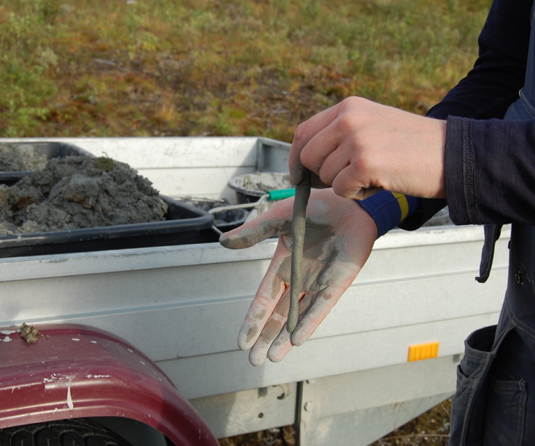Leire rullet ut mellom hendene. Jo lengre leirpølse man kan rulle ut slik bildet viser, jo bedre er kvaliteten. Foto: Kulturminnefondet