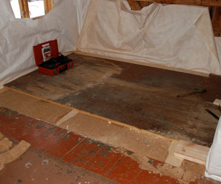 Det gamle golvet blir lagt tilbake oppå 50mm hamp. Den diffusjonsåpne vindsperren ligger under hampen. Grunnen til at golvplankene ligger ulike retninger er at det opprinnelig har vært to rom her. Foto: Ragnhild Dietrichson