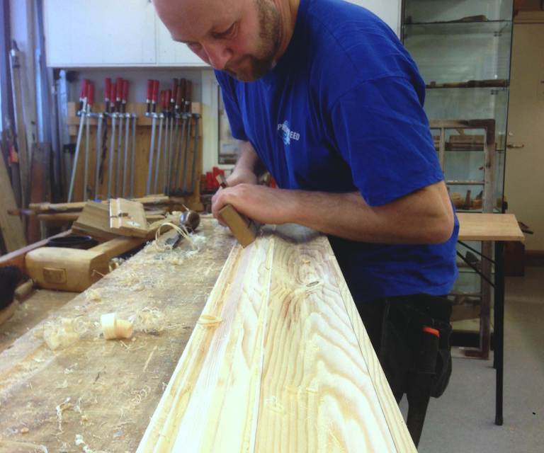 Det ble benyttet flere ulike høvler for å få frem profilene. Høvlene blir "styrt" av spor som tidligere er laget fra bordets kant. Foto: Glenn Løken. 